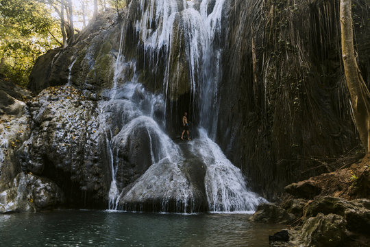 Man is climbing on waterfall