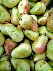 Bright colorful pears in a crate in a market