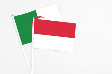 Indonesia and Algeria stick flags on white background. High quality fabric, miniature national flag. Peaceful global concept.White floor for copy space.