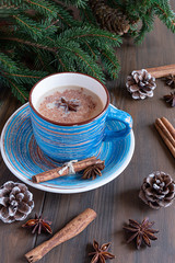 cup of masala tea with cinnamon and star anise on a wooden background 