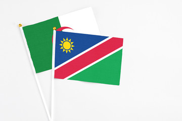 Namibia and Algeria stick flags on white background. High quality fabric, miniature national flag....
