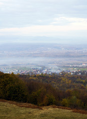 Obraz premium Panoramic view on fog village, Carpathian mountains, Ukraine. Vertical outdoors shot