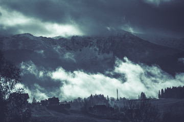 HDR photo of the Tatra Mountains and Great Giewont Peak with the steel Cross between clouds.