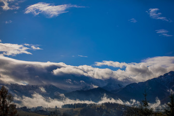 Fototapeta na wymiar HDR photo of the Tatra Mountains and Great Giewont Peak with the steel Cross between clouds.