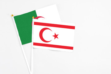 Northern Cyprus and Algeria stick flags on white background. High quality fabric, miniature...
