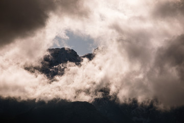 HDR photo of the Tatra Mountains and Great Giewont Peak with the steel Cross between clouds.