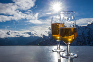 Glass of beer with the Serre Chevalier Alps in the background, France