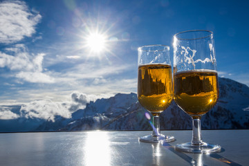 Glass of beer with the Serre Chevalier Alps in the background, France