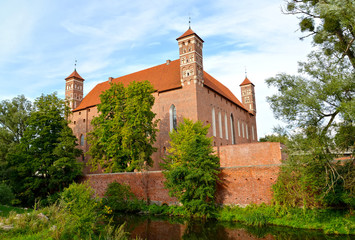 Fototapeta na wymiar Bishop 's Castle, surrounded by a moat with water. 14th century, Lidzbark-Varminsky. Poland