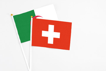 Switzerland and Algeria stick flags on white background. High quality fabric, miniature national...
