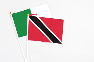Trinidad And Tobago and Algeria stick flags on white background. High quality fabric, miniature national flag. Peaceful global concept.White floor for copy space.