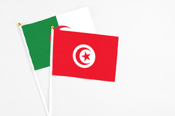 Tunisia and Algeria stick flags on white background. High quality fabric, miniature national flag....