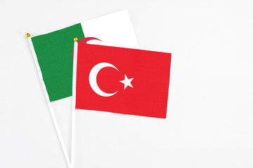 Turkey and Algeria stick flags on white background. High quality fabric, miniature national flag. Peaceful global concept.White floor for copy space.