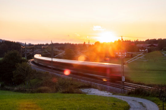 Germany, Upper Bavaria, Regional train at sunset