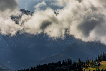 HDR photo of the Tatra Mountains and Great Giewont Peak with the steel Cross between clouds.