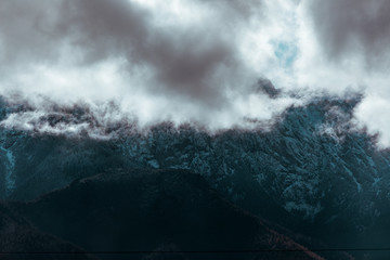 HDR photo of the Tatra Mountains and Great Giewont Peak with the steel Cross between clouds.