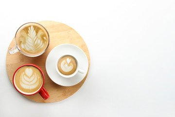Buch of coffee cups with different kind of beverage and different latte art foam designs. Top view, close up, copy space, background.