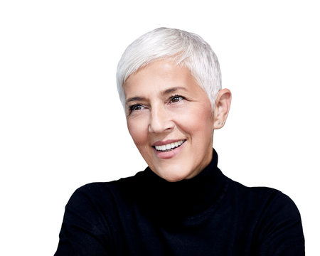 Portrait Of Mature Woman With Short Grey Hair Wearing Black Turtleneck Pullover Against White Background