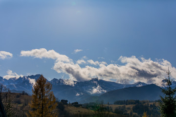 Obraz premium HDR photo of the Tatra Mountains and Great Giewont Peak with the steel Cross between clouds.