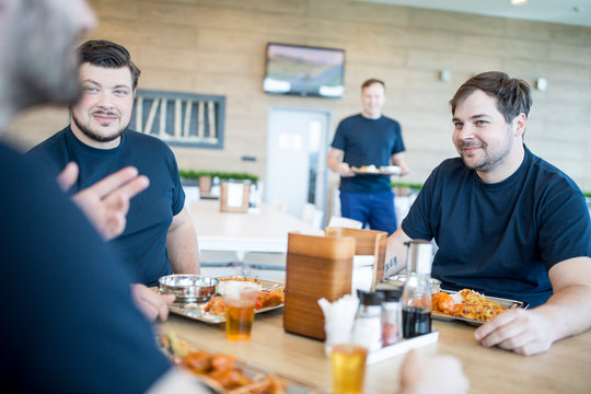 Colleagues having lunch break in canteen