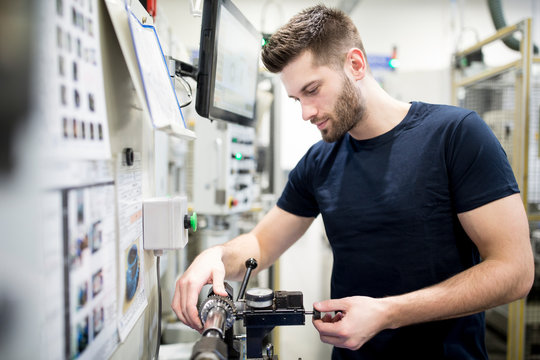 Man working in a modern factory operating a machine