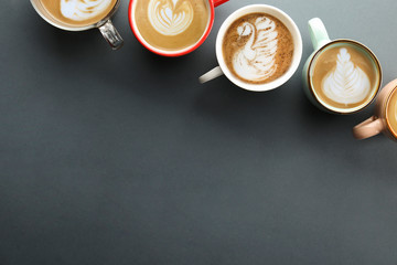 Buch of coffee cups with different kind of beverage and different latte art foam designs. Top view, close up, copy space, background.