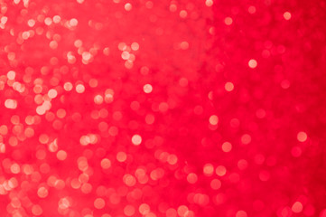 Super saturated vibrant red background of defocused boke sparkles