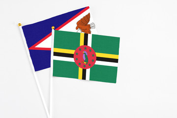 Dominica and American Samoa stick flags on white background. High quality fabric, miniature...