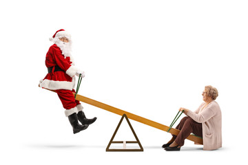 Santa Claus on a seesaw with an elderly woman