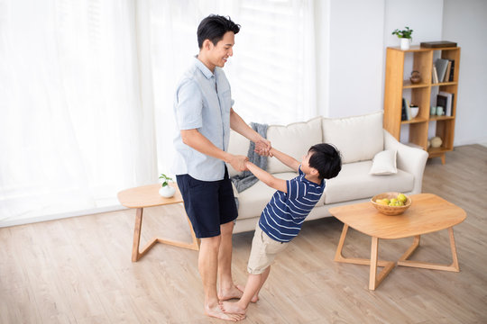 Chinese father and son playing in living room