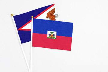 Haiti and American Samoa stick flags on white background. High quality fabric, miniature national...