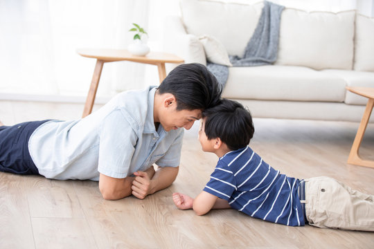 Chinese father and son lying on floor