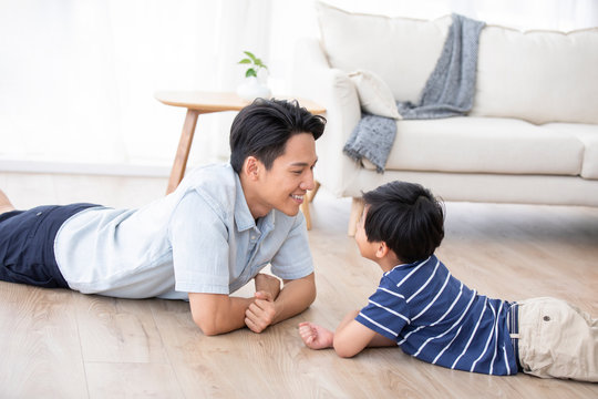 Chinese father and son lying on floor