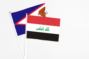 Iraq and American Samoa stick flags on white background. High quality fabric, miniature national flag. Peaceful global concept.White floor for copy space.