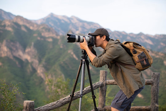 Chinese photographer taking photos outdoors