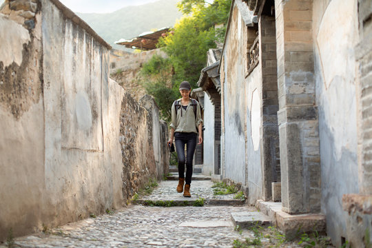 Chinese photographer walking in village