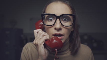 Shocked woman talking on the phone