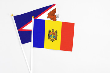 Moldova and American Samoa stick flags on white background. High quality fabric, miniature national flag. Peaceful global concept.White floor for copy space.