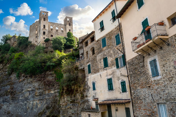 Fototapeta na wymiar The ancient hilltop castle above the medieval stone village in the Ligurian section of Italy at Dolceacqua.