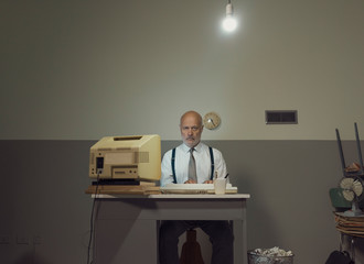 Sad businessman working in a small office