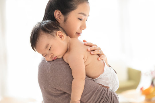 Young Chinese mom holding baby girl