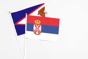 Serbia and American Samoa stick flags on white background. High quality fabric, miniature national...