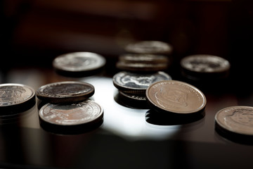 A pile of coins from different currencies and materials. Close up of small change.