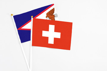 Switzerland and American Samoa stick flags on white background. High quality fabric, miniature...