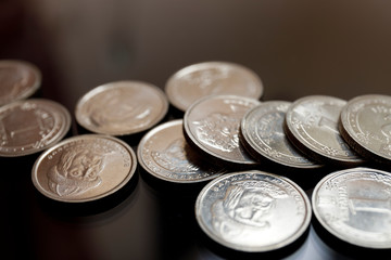 A pile of coins from different currencies and materials. Close up of small change.