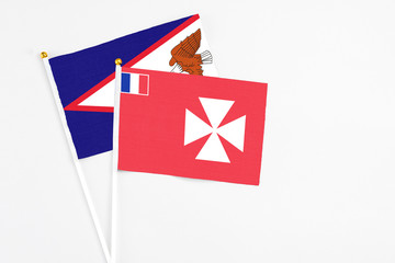 Wallis And Futuna and American Samoa stick flags on white background. High quality fabric,...