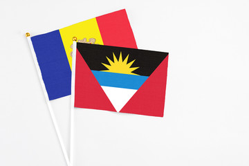 Antigua and Barbuda and Andorra stick flags on white background. High quality fabric, miniature national flag. Peaceful global concept.White floor for copy space.