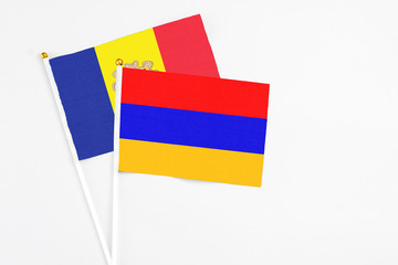 Armenia and Andorra stick flags on white background. High quality fabric, miniature national flag. Peaceful global concept.White floor for copy space.