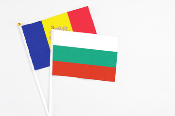 Bulgaria and Andorra stick flags on white background. High quality fabric, miniature national flag. Peaceful global concept.White floor for copy space.