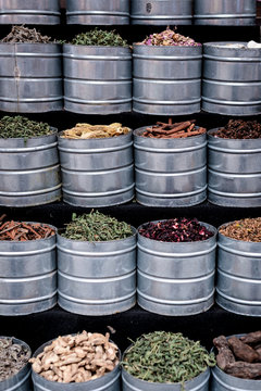 Metal jars with assorted dried spices located on stall on street market in Marrakesh, Morocco